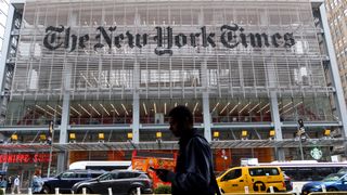 A person walks past the New York Times headquarters on 8th Avenue on May 16, 2024, in New York City.