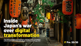 A photo of a back alley in a Japanese town showing orange lanterns and dimly lit shops